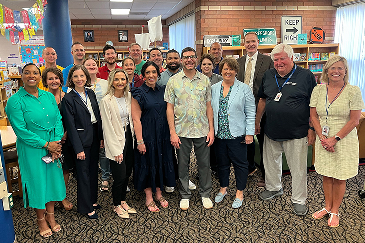 Tony Hartman, Middle Tennessee State University music education alumnus, fourth from the right in the front row, poses for a photo with Murfreesboro City Schools and Scales Elementary School educators and officials at Scales Elementary in Murfreesboro, Tenn., in early May 2024 during a celebration to announce his being named one of this year’s 30 CMA Foundation’s Music Teachers of Excellence. A total of six MTSU alumni won the award this year. (Submitted photo)