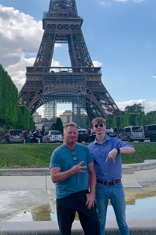 Middle Tennessee State University School of Journalism and Strategic Media instructor Dan Eschenfelder and his son Cameron, shown here in front of the Eiffel Tower in Paris during a study abroad trip, both finished their degrees in three years, Dan earning his master’s and Cameron his bachelor’s. The father and son, who had the opportunity to study abroad in Mexico, France, Scotland and England, wore matching study abroad flag sashes at their separate spring commencement ceremonies May 3 and May 4. (Photo courtesy of Dan Eschenfelder)