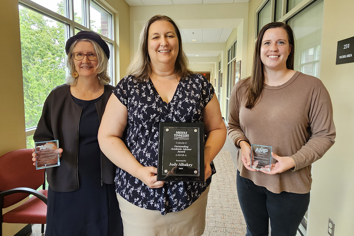 Middle Tennessee State University’s Judy Albakry, center, University Honors College advisor, holds her 2024 Outstanding Academic Advisor Award inside the Honors College Building on MTSU’s campus in Murfreesboro, Tenn. Pictured with her are fellow Honors advisors Laura Clippard, left, and Emilee Buckmeyer, right, who hold their certification awards from the university’s Advisor Mastery Program, or AMP, a professional learning community. Albakry also earned the AMP certification. (MTSU Photo by Robin E. Lee)