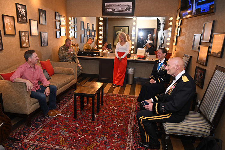 Grand Ole Opry member and Middle Tennessee State University alumnus Craig Morgan, seated left, chats backstage with retired Lt. Gen. Keith Huber, seated right, MTSU senior adviser for veterans and leadership initiatives, and Lt. Gen. Jody Daniels, also seated, commanding general of the U.S. Army Reserve at the Opry’s Salute the Troops celebration held Tuesday, May 21, in Nashville, Tenn. Morgan, who is a warrants officer in the Army Reserve, performed at the event where both generals were special guest announcers. (MTSU photo by James Cessna)