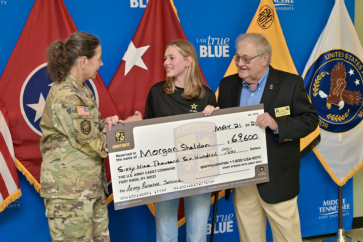 Lt. Gen. Jody Daniels, left, commanding general of the U.S. Army Reserve, presents a full Minuteman ROTC scholarship to incoming Middle Tennessee State University freshman Morgan Sheldon, of Murfreesboro, Tenn., at the Army ROTC Building during Daniels’ visit Tuesday, May 21, to the campus in Murfreesboro, Tenn. (MTSU photo by J. Intintoli)