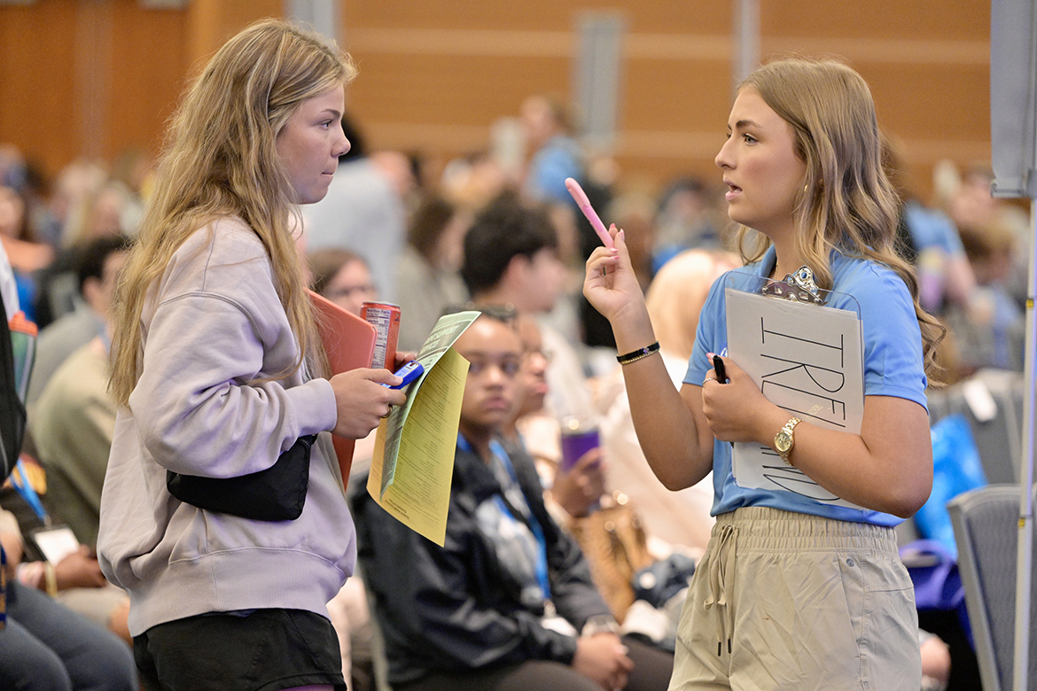 Middle Tennessee State University Student Orientation Assistant Emmie Neagle, right, of Rockvale, Tenn., checks in a new student and answers her questions Tuesday, May 14, during CUSTOMS orientation in the Student Union Ballroom on the MTSU campus in Murfreesboro, Tenn. Several hundred Class of 2028 members and their parents began the acclimation process during the all-day event. Neagle is a biochemistry major in the pre-physician assistant studies program. (MTSU photo by Andy Heidt)