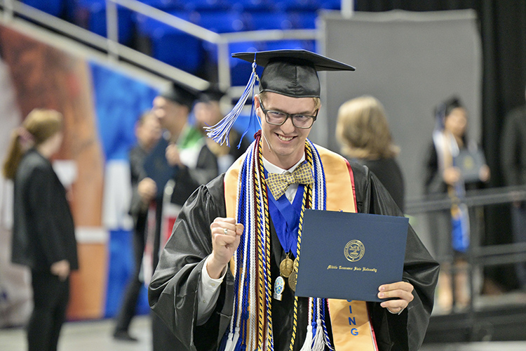 A proud Middle Tennessee State University graduate pumps his fist after receiving his diploma during the Friday, May 3, commencement ceremony at Murphy Center in Murfreesboro, Tenn. It was the first of three ceremonies Friday and Saturday, May 4, to celebrate the total 2,439 graduates for the spring Class of 2024. (MTSU photo by J. Intintoli)