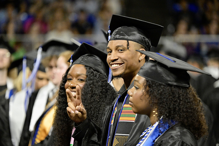Middle Tennessee State University College of Media and Entertainment graduate Nick Edgerson flashes the peace sign to supporters during the Saturday, May 4, afternoon spring commencement ceremony at Murphy Center in Murfreesboro, Tenn. It was the last of three ceremonies May 3-4. (MTSU photo by Andy Heidt)