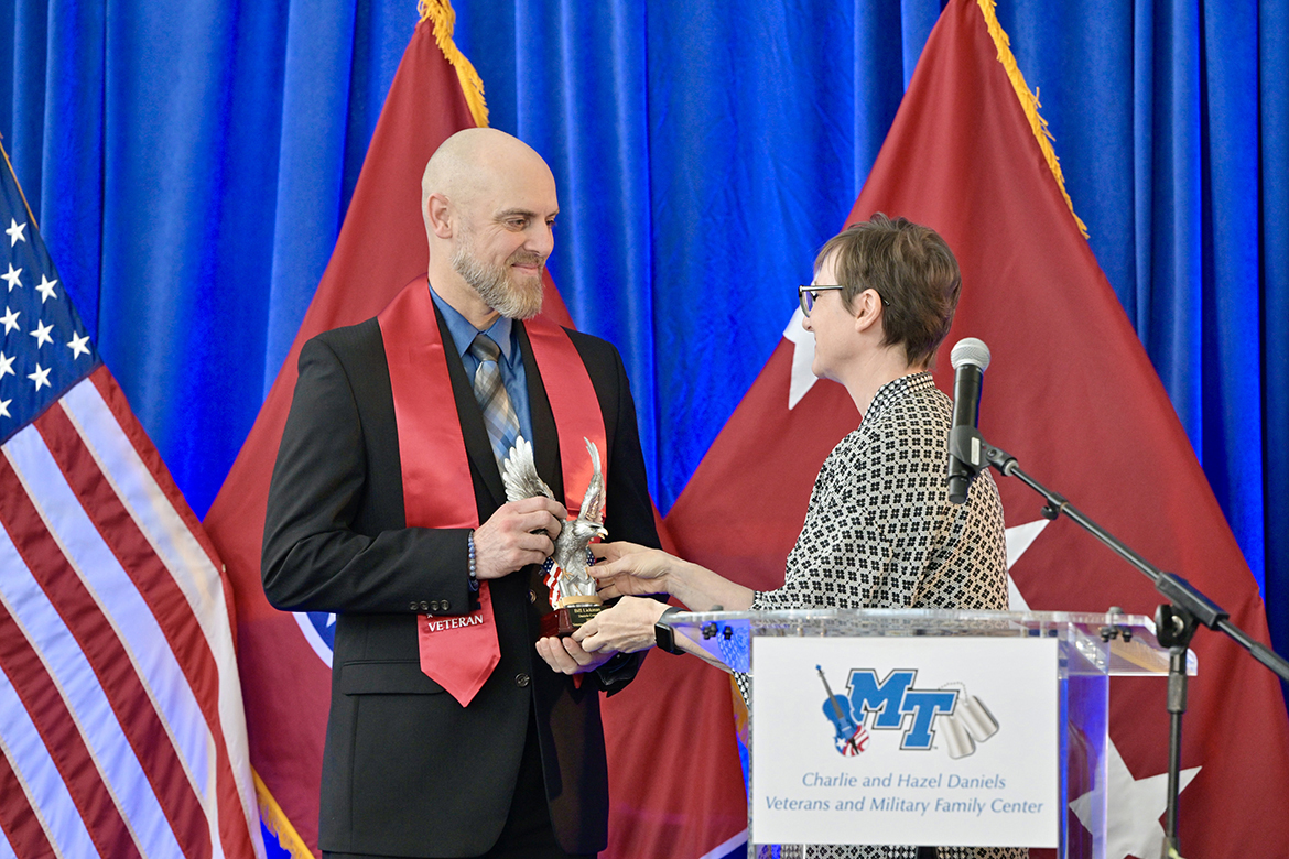 Middle Tennessee State University graduating senior student veteran Bill Lickman, left, accepts the Charlie and Hazel Daniels Veterans and Military Family Center Veteran Leadership Award from Laurie Witherow, interim vice provost for Enrollment Services, Thursday, May 2, during the Graduating Veterans Stole Ceremony at the Miller Education Center on Bell Street in Murfreesboro, Tenn. the award is given to a graduating student veteran who has demonstrated superior leadership, academic achievement and selfless service to MTSU and the Daniels Center community. Lickman was both a survivor and hero of the 9/11 terrorist attacks at the Pentagon in Washington, D.C., on Sept. 11, 2001. (MTSU photo by Andy Heidt)