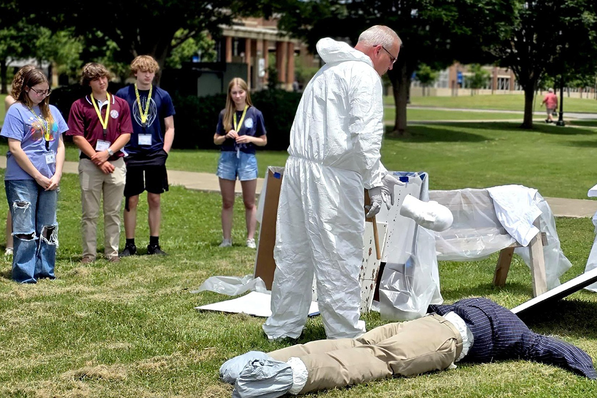 Lt. James Abbott, a detective with the Murfreesboro Police Department and a Middle Tennessee State University adjunct professor in criminal justice, instructs attendees in the somewhat messy art of blood spatter interpretation at the 2024 CSI: MTSU Forensic Summer Youth Camp for high schoolers held June 11-14 on the MTSU campus in Murfreesboro, Tenn. (Submitted photo)