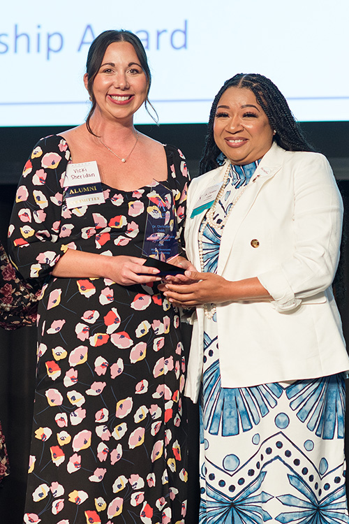 Middle Tennessee State University associate professor Christina Cobb, right, is presented the Rutherford Cable 2024 ATHENA Young Professional Leadership Award from Vickie Sheridan, nominee liaison and 2022 winner of the same award, during a banquet held May 17, 2024, in MTSU’s Student Union Ballroom on campus in Murfreesboro, Tenn. Cobb, who teaches math in MTSU’s University Studies, was one of eight women nominated for the award, which recognizes an emerging leader under age 40. (Submitted photo)