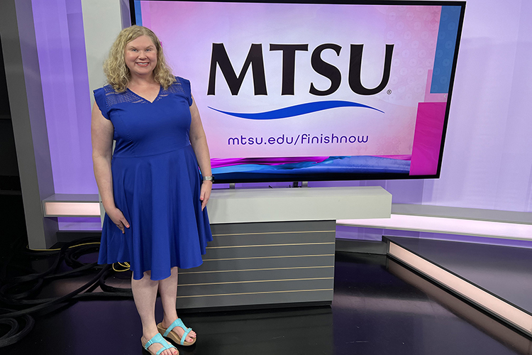 Mary Beth Asbury, professor and chair of the Department of Communication Studies at Middle Tennessee State University, stands next to the MTSU logo displayed on a monitor in the studio for WKRN-TV News 2’s Local on 2 program in Nashville, Tenn. Asbury recently appeared for an interview with program co-host and producer Laura Schweizer to provide tips on good communication. Asbury’s segment is part of the station’s new “MTSU on 2” partnership to spotlight university faculty and staff expertise and programs. (MTSU photo by Matthew Hibdon)