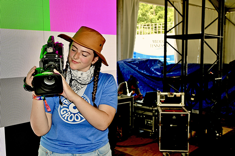 MTSU College of Media and Entertainment student Lane Stanley checks her camera during an equipment check Wednesday before the start of the Bonnaroo Music and Arts Festival, where students will be broadcasting concerts from two of the event’s five stages during the four days. (MTSU Photo by Andrew Oppmann)