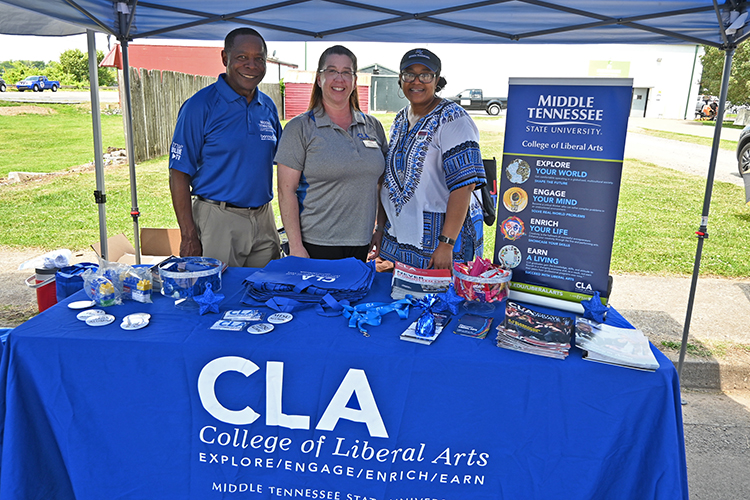 From left, Middle Tennessee State University President Sidney A. McPhee, College of Liberal Arts Events Coordinator Jennifer Rice, and College of Liberal Arts Dean Leah Lyons pause for a photo at the college’s informational table at the 2024 Murfreesboro Juneteenth celebration and street festival held Saturday, June 15, in front of the Bradley Academy Museum and Cultural Center along South Academy Street in Murfreesboro, Tenn. (MTSU photo by Jimmy Hart)