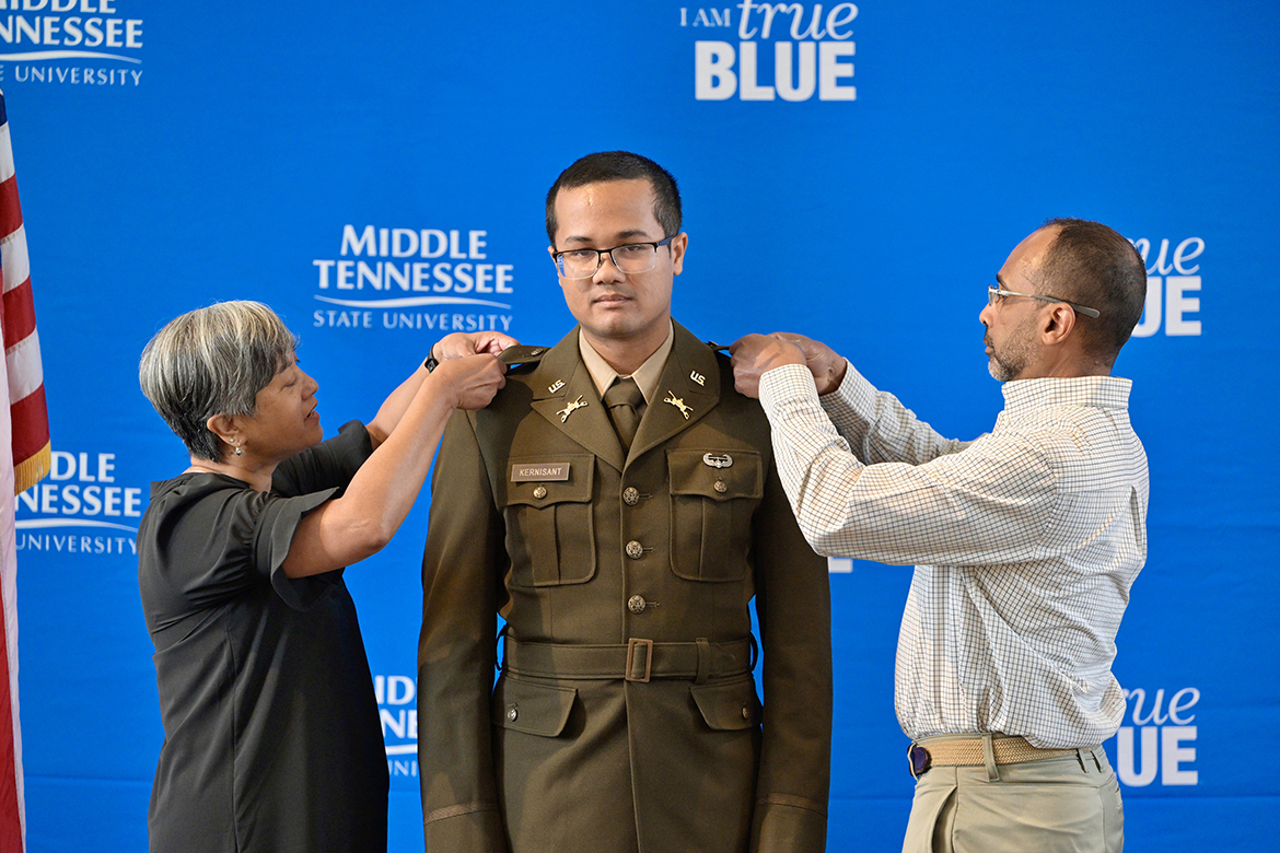 Nora Kernisant, left, and Robert Kernisant, right, of Murfreesboro, Tenn., pin U.S. Army second lieutenant bars on their son Sebastien Kernisant as part of the Middle Tennessee State University Blue Raider Battalion spring commissioning ceremony, held May 3 in the Tom H. Jackson Building’s Cantrell Hall on the MTSU campus in Murfreesboro. Sebastien Kernisant earned a bachelor’s degree in psychology and will be active duty in the armor branch. After attending Camp Cadre at Fort Knox, Ky., he will report to Fort Moore, Ga., in August for the Basic Officer Leader Course. (MTSU photo by Andy Heidt)