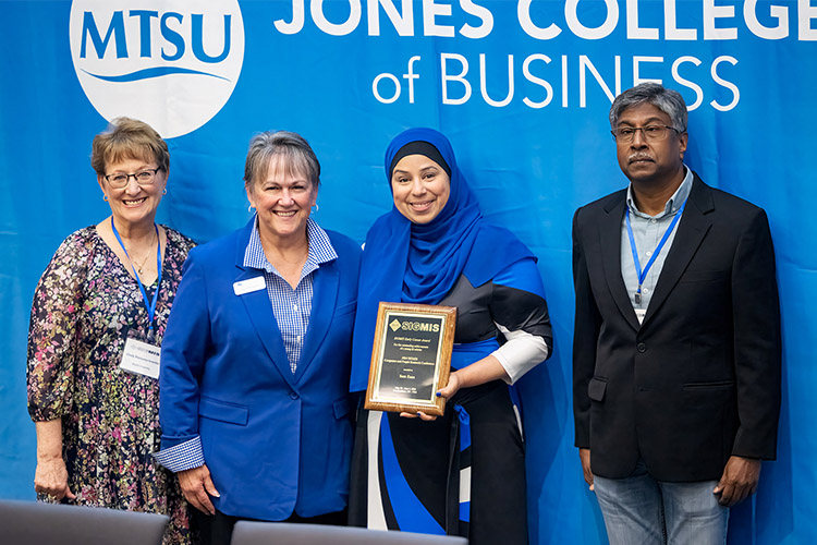 Sam Zaza, second from right, professor in the Department of Information and Analytics at Middle Tennessee State University, is presented with the Early Career Award on May 30, 2024, during the inauguration and award ceremony at the ACM SIGMIS CPR 2024 conference hosted on the MTSU campus in Murfreesboro, Tenn. Pictured, from left, are Cindy Riemenschneider, information systems professor at Baylor University; Joyce Heames, dean of MTSU’s Jones College of Business; Zaza; and Damien Joseph, ACM SIGMIS chair. Zaza was also the chair of the annual conference, held at MTSU for the first time. (MTSU photo by Andy Heidt)