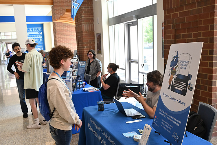 Joe Taylor, a University Writing Center tutor and Ph.D. candidate in the English Department at Middle Tennessee State University, shares information about the center with students on Thursday, May 13, 2024, during a CUSTOMS new student orientation inside MTSU’s Student Union Building in Murfreesboro, Tenn. (MTSU photo by Johari Hamilton)