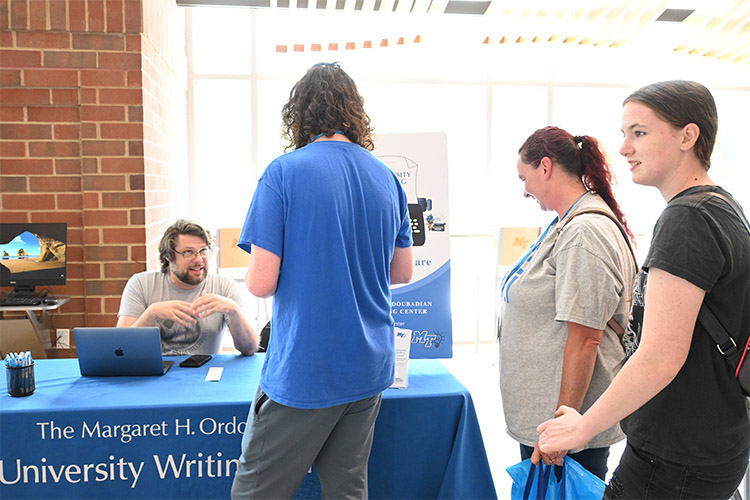 Joe Taylor, a University Writing Center tutor and Ph.D. candidate in the English Department at Middle Tennessee State University, shares information about the center with incoming students and their parents on Thursday, May 13, 2024, during a CUSTOMS new student orientation inside MTSU’s Student Union Building in Murfreesboro, Tenn. (MTSU photo by Johari Hamilton)