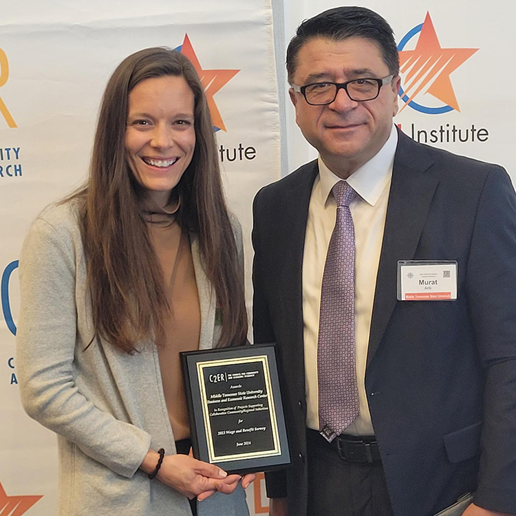 Dr. Murat Arik, right, director of the Business and Economic Research Center at Middle Tennessee State University, and BERC Executive Assistant Andrea Lawrence accept the Community, Economic, and Workforce Research Award at the annual Council for Community and Economic Research, or C2ER, Conference in Norfolk, Va., in mid-June 2024 in recognition of the center’s 2023 wages and benefits study. (Submitted photo)