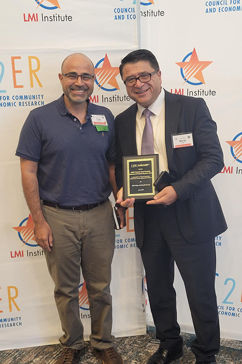 Dr. Murat Arik, right, director of the Business and Economic Research Center at Middle Tennessee State University, poses with Dr. Fady Mansour, MTSU economics alumnus and director of the Butler Center for Research and Economic Development at Columbus State University, after Arik accepted the Community, Economic, and Workforce Research Award at the annual Council for Community and Economic Research, or C2ER, Conference in Norfolk, Va., in mid-June 2024 in recognition of the center’s 2023 wages and benefits study. (Submitted photo)