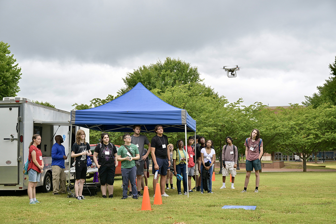 A group of participants in the 2024 Middle Tennessee State University College of Basic and Applied Sciences STEM Camp watch an automatic mission and later have an opportunity to fly an MTSU Aerospace Department unmanned aircraft systems vehicle, or drone, on campus recently in Murfreesboro, Tenn. High school students from around the Midstate spent five days experiencing hand-on science, technology, engineering, match and more during the camp. (MTSU photo by Andy Heidt)