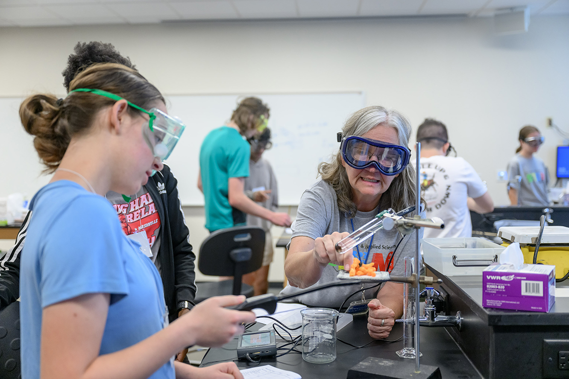 MTSU 2024 STEM Camp2.jpg

While Middle Tennessee State University College of Basic and Applied Sciences STEM Camp participants wait to a start the burning process with a lighter, MTSU Chemistry Department Chair Amy Phelps, center, prepares cheese curls in a process to determine how many calories are in the food. The activity occurred Tuesday, July 16, in the Science Building chemistry lab on the MTSU campus in Murfreesboro, Tenn. (MTSU photo by J. Intintoli)
