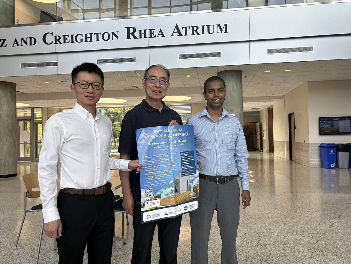 Holding a poster promoting the 59th Actuarial Research Conference being held Middle Tennessee State University in Murfreesboro, Tenn., are, from left, Department of Mathematical Sciences assistant professor Lu Xiong, professor Don Hong and assistant professor Vajira Manathunga. Many actuarial science faculty, students and industry leaders will be in attendance for conference events being held July 17-20 in the MTSU Student Union. (MTSU photo by Randy Weiler)