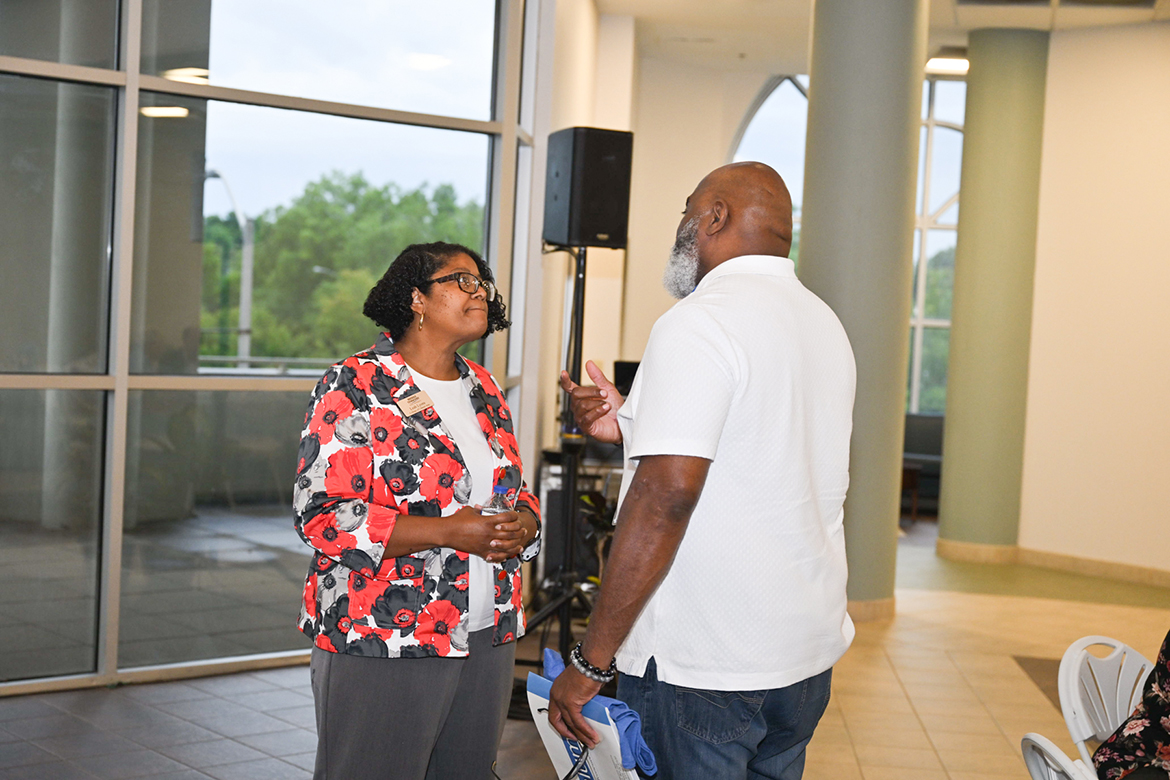 Leah Tolbert Lyons, left, dean of the Middle Tennessee State University College of Liberal Arts, listens as alumnus Andre Dyer (Class of 1991) of Lawrenceville, Ga., talks about his time as a student-athlete when he attended the Murfreesboro, Tenn., university. Their conversation took place during the dinner on the opening day of the 15th annual Alumni Summer College Wednesday, June 26, in the second-floor atrium in the Miller Education Center on Bell Street. Nearly 75 alumni attended Alumni Summer College with the theme of the future of analytics and artificial intelligence, or AI. Dyer earned his degree from the Jones College of Business and played football for the Blue Raiders. (MTSU photo by James Cessna)