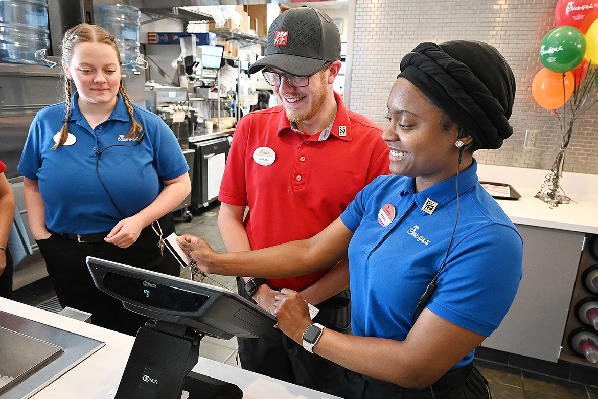 Middle Tennessee State University Tourism and Hospitality Management Program student Kenady Rix, a front counter shift leader and summer operations intern at Chick-fil-A in Murfreesboro, Tenn., works with employees Hope Hutchins, left, and Jaekob LaCoursier. Students in the program are required to work in the tourism, hospitality and events industry as part of coursework, logging at least 300 hours in two different semesters. (MTSU photo by Nancy DeGennaro)