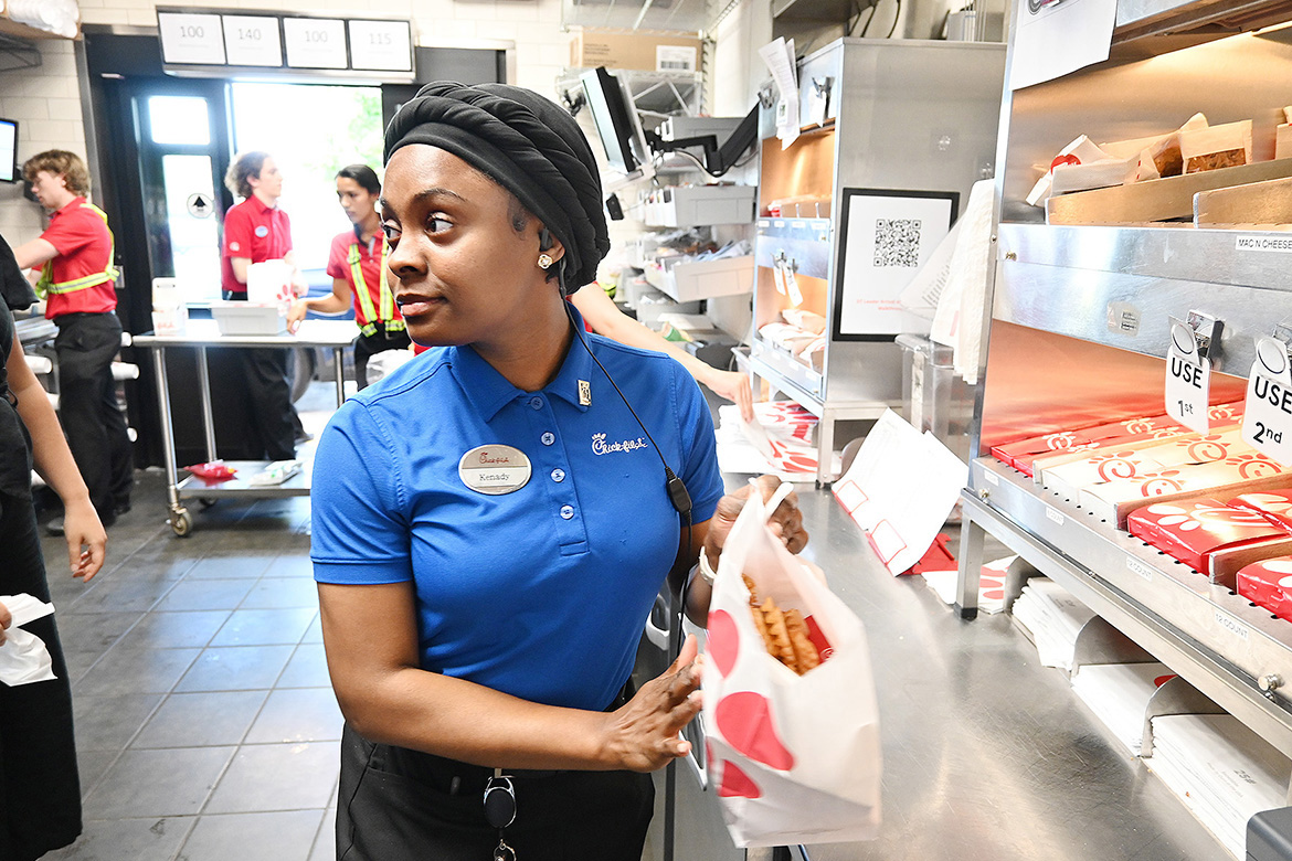 Middle Tennessee State University Tourism and Hospitality Management Program student Kenady Rix, a front counter shift leader and summer operations intern at Chick-fil-A in Murfreesboro, Tenn., prepares an order during a busy lunch rush. The program has been designated as the first and only accredited hospitality degree program in the state — a boost for students like Rix, who plan a career in the industry. Rix said, “I see myself growing further as a leader within the hospitality industry in the years to come.” (MTSU photo by Nancy DeGennaro)