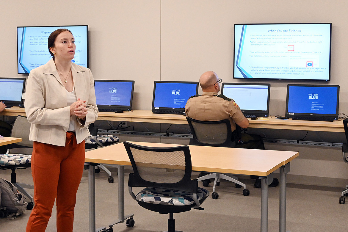 McKenzie Adams, Industrial-Organizational Psychology graduate student at Middle Tennessee State University in Murfreesboro, Tenn., speaks to a class of Tennessee Highway Patrol troopers and sergeants on campus earlier this summer vying for promotions during an examination process designed by students in MTSU’s Center for Organizational and Human Resource Effectiveness, or COHRE. (MTSU photo by Nancy DeGennaro)