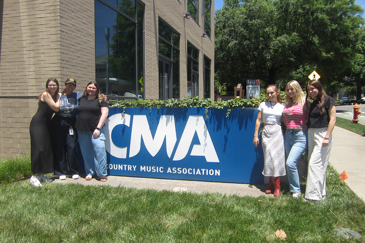 In this undated photo, Middle Tennessee State University alumna and recording industry graduate Liliana Manyara, second from left, poses in front of the Country Music Association’s sign outside of the downtown Nashville, Tenn., office with other interns. (Photo submitted)