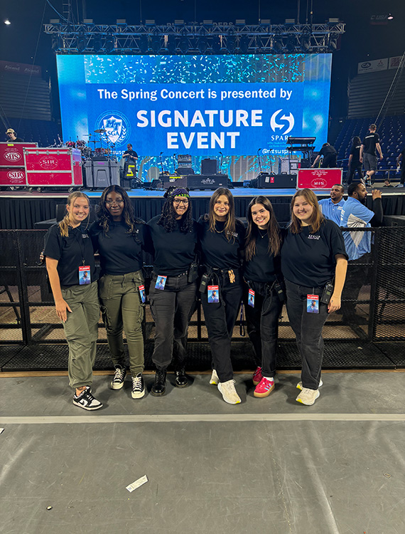 Middle Tennessee State University alumna and spring recording industry graduate Liliana Manyara, third from the left, stands in front of the stage with other members of the MTSU Signature Events committee who booked singer-songwriter Khalid for the 2024 spring concert at MTSU’s Murphy Center in Murfreesboro, Tenn. (Photo submitted)