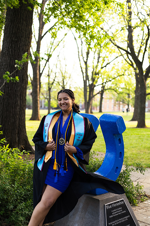 Middle Tennessee State University spring graduate Liliana Manyara, a recording industry management alumna, poses for graduation photos at the horseshoe in Middle Tennessee State University’s Walnut Grove in Murfreesboro, Tenn. (Photo submitted)