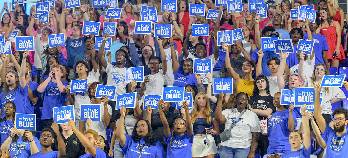 New Middle Tennessee State University freshmen and transfer students hold “I AM true BLUE” signs in the air and cheer moments after reciting the True Blue Pledge of core values Saturday, Aug. 24, during the 23rd University Convocation in Murphy Center in Murfreesboro, Tenn. (MTSU photo by J. Intintoli)