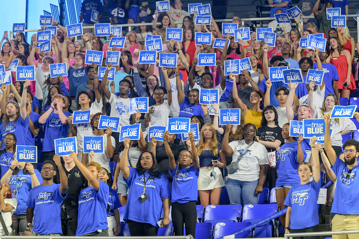 New Middle Tennessee State University freshmen and transfer students hold “I AM true BLUE” signs in the air and cheer moments after reciting the True Blue Pledge of core values Saturday, Aug. 24, during the 23rd University Convocation in Murphy Center in Murfreesboro, Tenn. (MTSU photo by J. Intintoli)