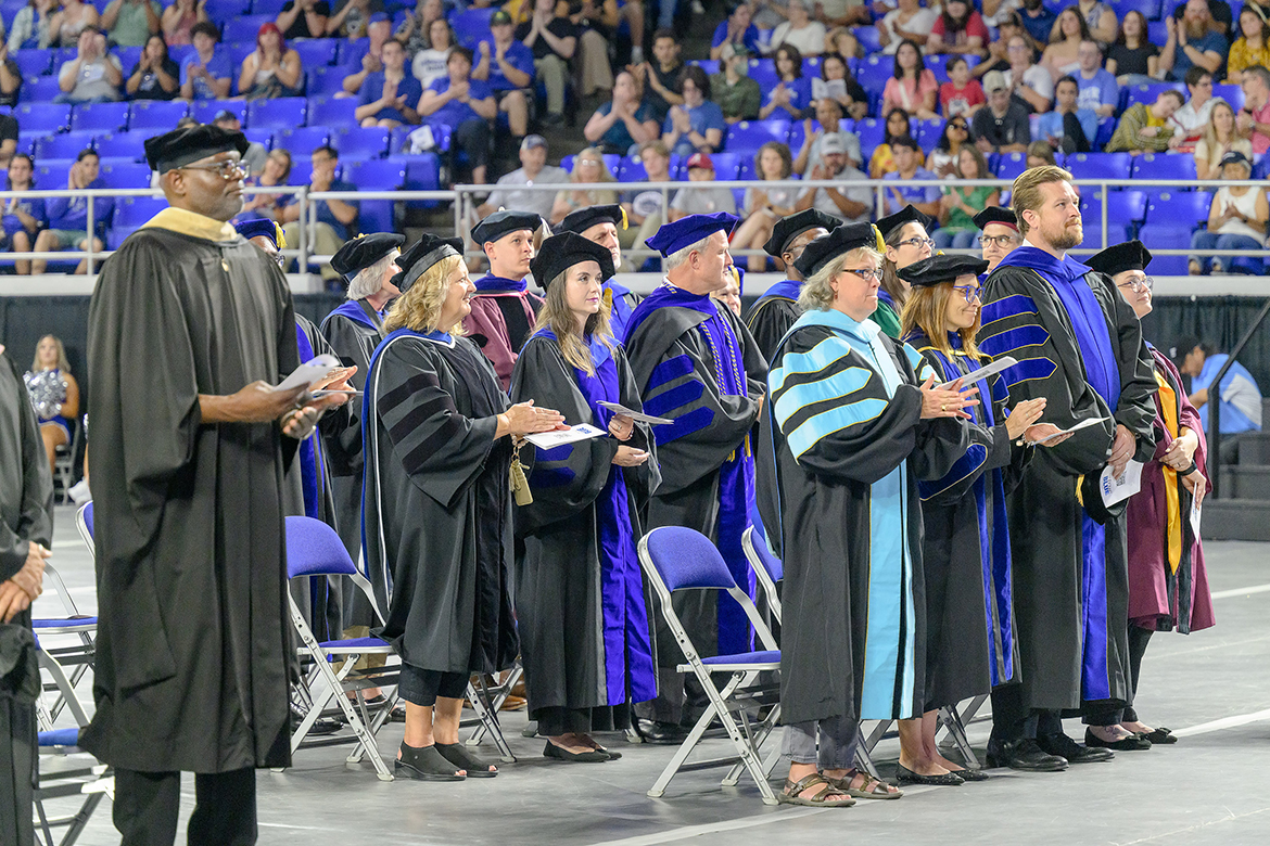 Shown standing early in the ceremony and wearing their academic regalia, Middle Tennessee State University faculty members joined college deans and other administrators during University Convocation Saturday, Aug. 24, in Murphy Center in Murfreesboro, Tenn. Convocation marks the official kickoff to the fall semester and 2024-25 academic year. (MTSU photo by J. Intintoli)