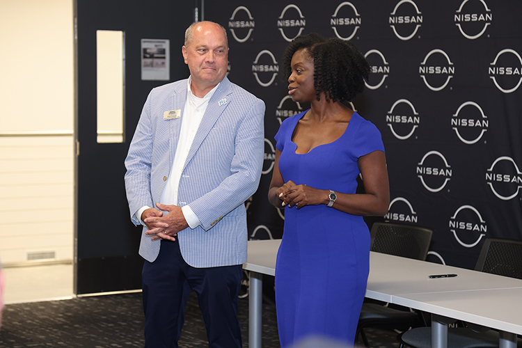 Middle Tennessee State University College of Education Dean Neporcha Cone, right, speaks at Nissan’s Partners in Education Signing Day event at the automaker’s manufacturing plant in Decherd, Tenn., July 29, 2024. At right is MTSU Director of Strategic Partnerships Brad Tammen. The event celebrated the establishment of Nissan Centers of Excellence at nearby high schools to provide training to those students. MTSU education faculty is helping train Nissan employees to teach those courses full time. (Submitted photo)