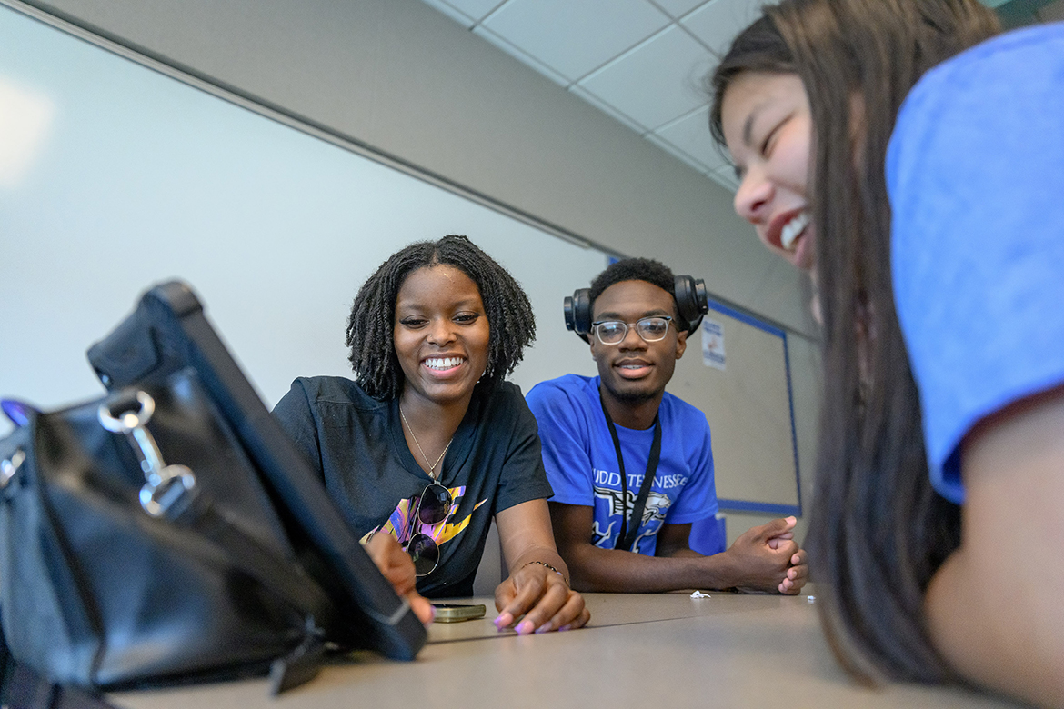 New Middle Tennessee State University students Timaress Hearns, left, of Memphis, Tenn., Jason Smallwood of Memphis and Avery McGiboney of McMinnville, Tenn., use their cell phones and a tablet during the “Escape Game” session with the fall 2024 Scholars Academy Freshman Summer Institute Tuesday, Aug. 13, in a College of Education classroom on the MTSU campus in Murfreesboro, Tenn. Notetaking, interviewing, computer technology and more were part of the nearly two-week program. (MTSU photo by J. Intintoli