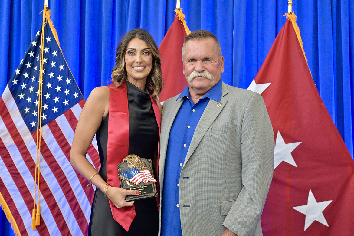 Middle Tennessee State University graduating senior veteran Maranda Vecchio, left, of Murfreesboro, holds the Journey Award presented to her Friday, Aug. 9, during the annual summer Graduating Veterans Stole Ceremony at the Miller Education Center on Bell Street in Murfreesboro, Tenn. She is shown with David Corlew, co-founder of the Journey Home Project started with the late country music legend Charlie Daniels. (MTSU photo by Andy Heidt)