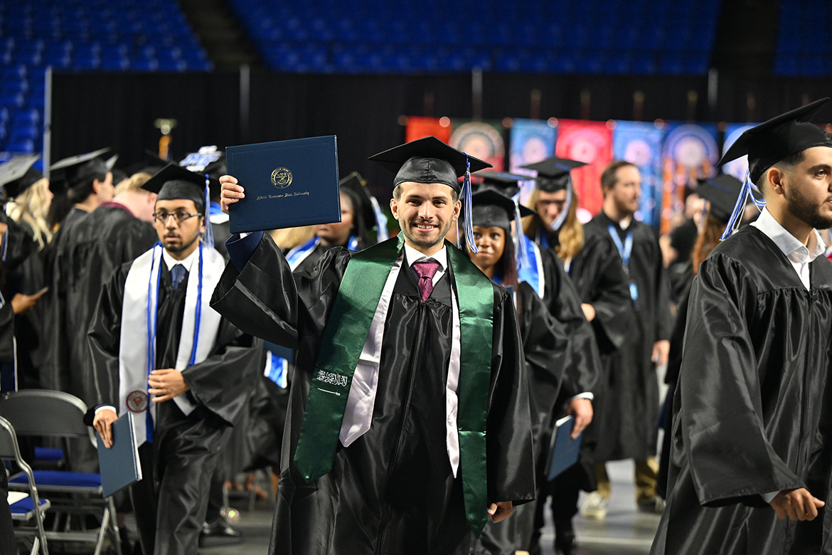 A proud Middle Tennessee State University graduate holds up his diploma at the university’s summer 2024 commencement ceremony held Saturday, Aug. 10, inside Murphy Center on the MTSU campus in Murfreesboro, Tenn. More than 770 graduates received their degrees. (MTSU photo by James Cessna)