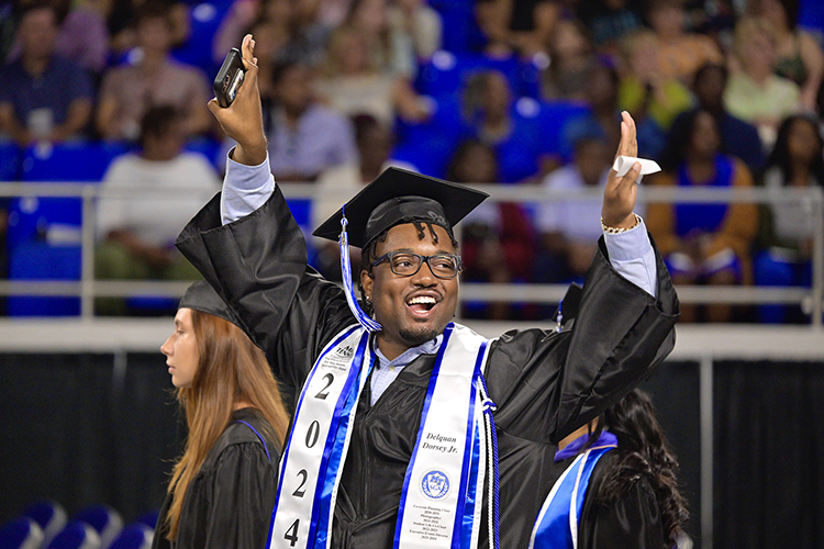 Middle Tennessee State University recording industry graduate Delquan Dorsey Jr. raises his hands in celebration at the university’s summer 2024 commencement ceremony held Saturday, Aug. 10, inside Murphy Center on the MTSU campus in Murfreesboro, Tenn. More than 770 graduates received their degrees. (MTSU photo by Andy Heidt)