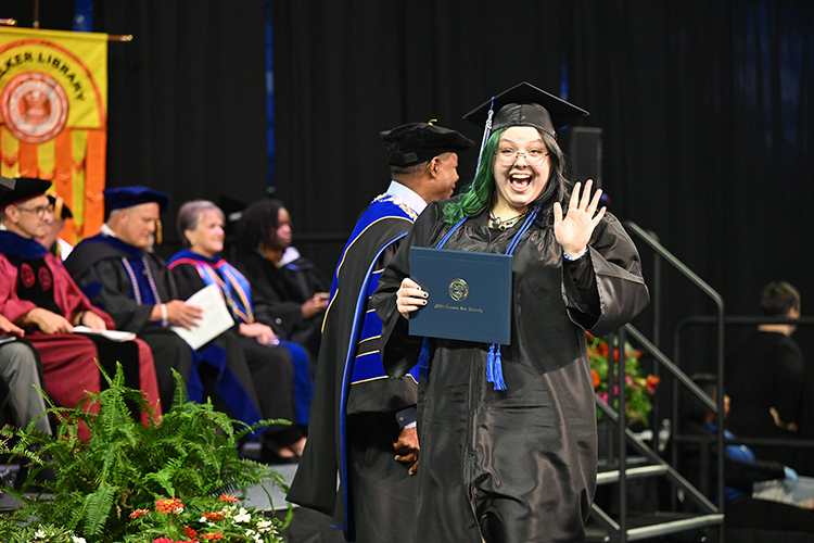 A proud Middle Tennessee State University graduate gives a wave after accepting her diploma at the university’s summer 2024 commencement ceremony held Saturday, Aug. 10, inside Murphy Center on the MTSU campus in Murfreesboro, Tenn. More than 770 graduates received their degrees. (MTSU photo by James Cessna)