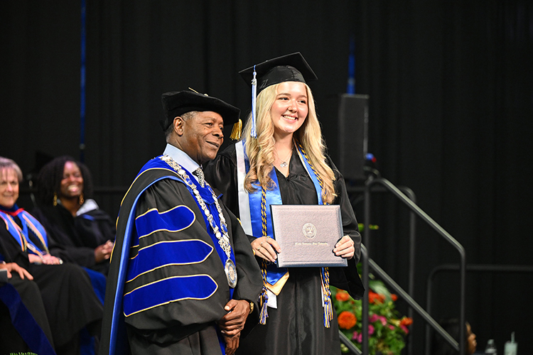 Middle Tennessee State University journalism graduate Maddy Williams, right, poses with university President Sidney A. McPhee after receiving her diploma at the summer 2024 commencement ceremony held Saturday, Aug. 10, inside Murphy Center on the MTSU campus in Murfreesboro, Tenn. More than 770 graduates received their degrees. (MTSU photo by James Cessna)