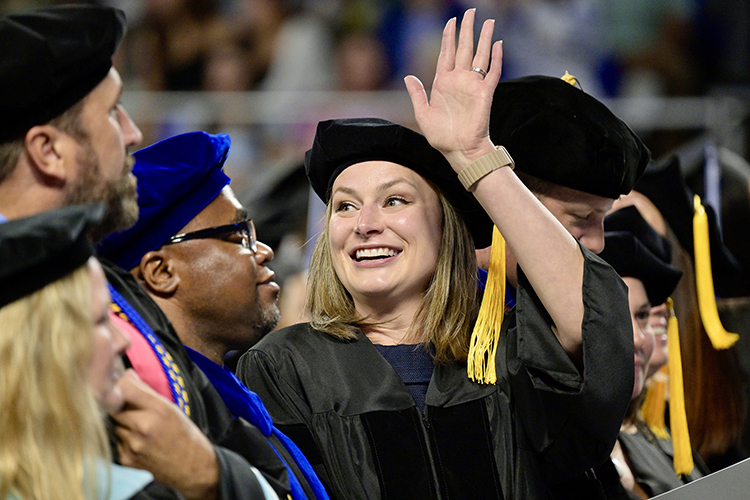 Middle Tennessee State University graduate Trisha Murphy, development director for the MTSU College of Education, waves to a supporter as she prepares to be hooded for earning her doctoral degree in education at the university’s summer 2024 commencement ceremony held Saturday, Aug. 10, inside Murphy Center on the MTSU campus in Murfreesboro, Tenn. More than 770 graduates received their degrees. (MTSU photo by Andy Heidt)