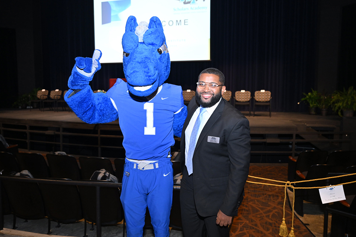 Michai Mosby, who is heading into his second year as president of the Student Government Association at Middle Tennessee State University in Murfreesboro, Tenn., stands with school mascot Lightning inside Tucker Theatre during the Scholars Academy for incoming students this summer. (MTSU photo by James Cessna)