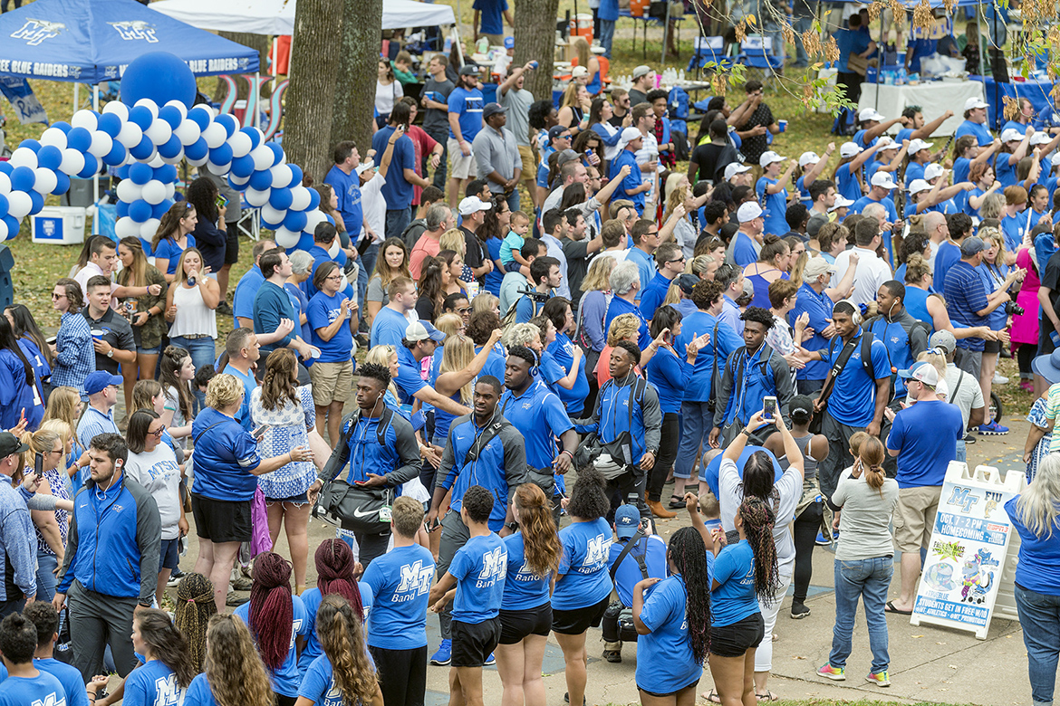 This file photo shows the traditional Raider Walk by members of Middle Tennessee State University's Blue Raider football team in front of Peck Hall in the Walnut Grove area on the west side of campus in Murfreesboro, Tenn. MTSU will launch an enhanced pregame experience at home football games this fall with the new Party in the Grove featuring live music, food trucks, tailgating and more. (MTSU file photo by J. Intintoli)