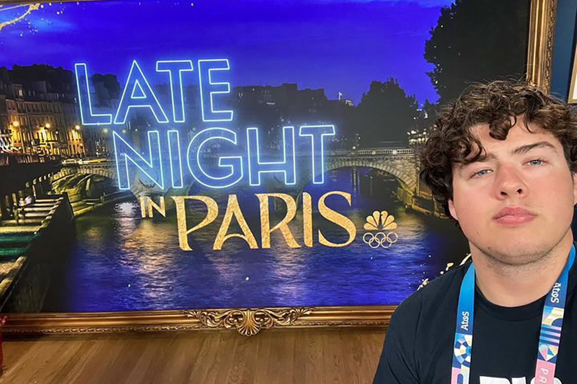 Middle Tennessee State University senior video and film production major Tobin Smith stands in front of a sign for NBC sportscaster Maria Taylor’s “Late Night in Paris” show that he worked production on during the summer Olympics in Paris, France. (Photo submitted)