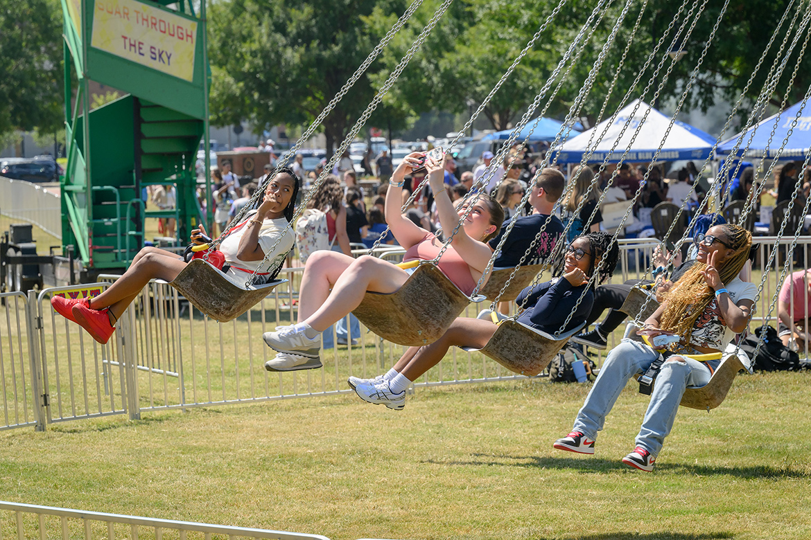 Middle Tennessee State University students pose for a selfie as they enjoy the carousel ride on hand at the Back to School Bonanza held Aug. 26 on the Student Union Commons on the east side of the MTSU campus in Murfreesboro, Tenn. (MTSU photo by J. Intintoli)