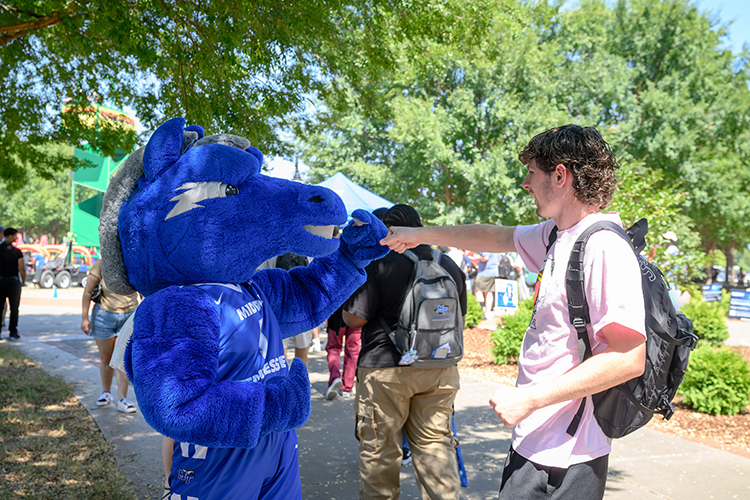 Middle Tennessee State University’s mascot Lightning greets a student during the Back to School Bonanza held Aug. 26 on the Student Union Commons on the east side of the MTSU campus in Murfreesboro, Tenn. (MTSU photo by J. Intintoli)