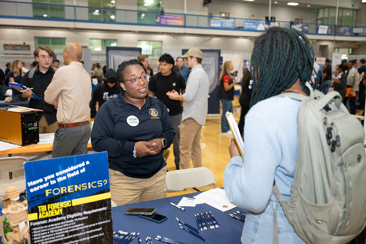 A Middle Tennessee State University student meets with Rudie McGowen, a representative from the Tennessee Bureau of Investigation’s Forensic Academy, one of the 235 companies at the Career Development Center’s 2024 Big Career fair in the Campus Recreation Center in Murfreesboro, Tenn. (MTSU photo by James Cessna)