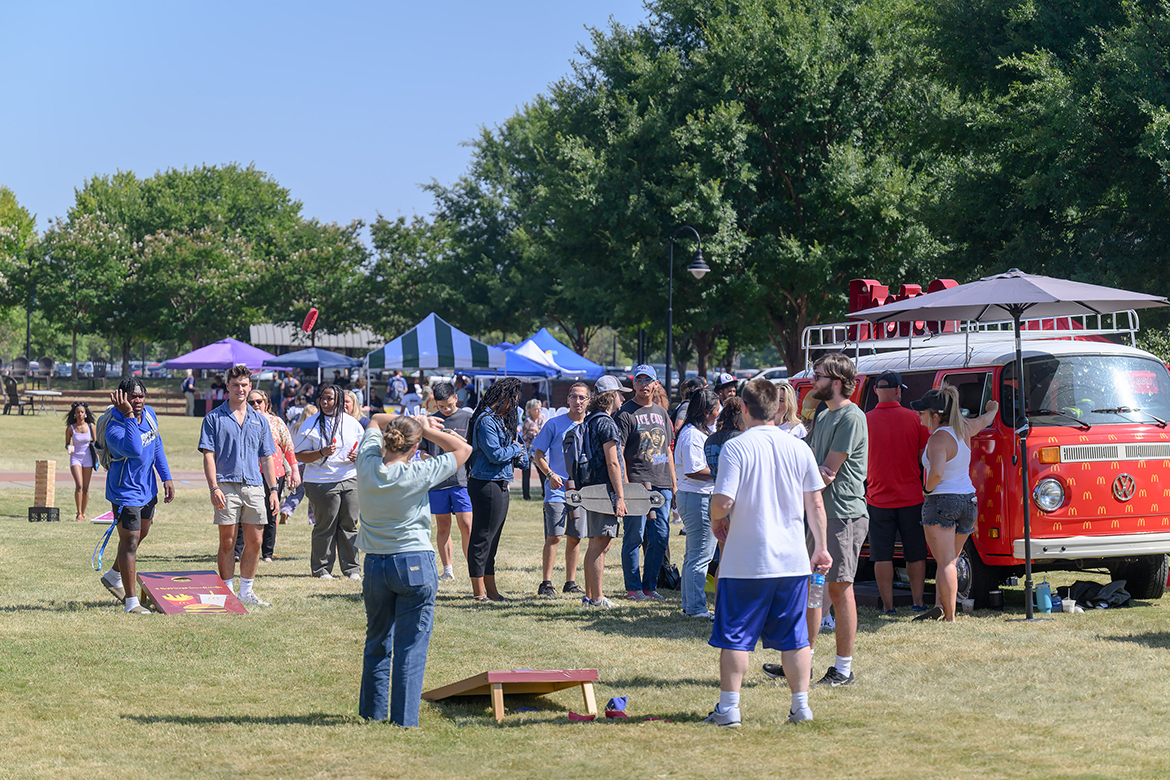 Middle Tennessee State University students enjoy playing cornhole, a bean toss game, next to the McDonald’s Photo Bus during the annual Meet Murfreesboro event in the Student Union Commons in Murfreesboro, Tenn. (MTSU photo by J. Intintoli)