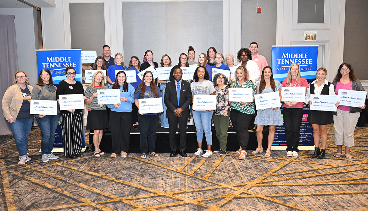 Middle Tennessee State University President Sidney A. McPhee, center, stands with high school counselors and community college advisors who were each given $2,500 scholarships to dole out to their students at the Murfreesboro, Tenn., university’s True Blue Tour recruitment stop held Wednesday, Sept. 25, at the Marriott Hotel in Franklin, Tenn. (MTSU photo by James Cessna)