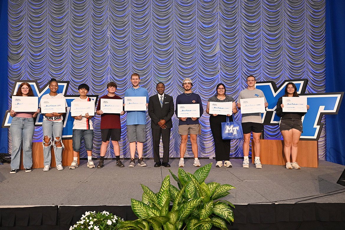 Middle Tennessee State University President Sidney A. McPhee, center, stands with students who were among the lucky winners in the scholarship drawings at MTSU’s True Blue Tour recruitment stop for prospective students held Wednesday, Sept. 11, in the Student Union Ballroom on campus in Murfreesboro, Tenn. Pictured, from left, are Elizabeth Guider, Jhaniah Nelson, Jonathan Ajpacaja, Phoenix Leeman, Bradley Cukr, McPhee, Trent Bromley, Hannah Rodriguez, Sam Curtis and Sophie Womack. (MTSU photo by James Cessna)